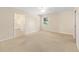 Spacious main bedroom with carpet, a ceiling fan, and a view through the window at 2750 Coral Reef Way, Tavares, FL 32778