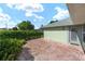 Back patio featuring lush landscaping and privacy hedge at 2750 Coral Reef Way, Tavares, FL 32778