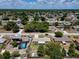 Wide aerial view of a neighborhood showcasing tree-lined streets, homes, and swimming pools at 2833 Beal St, Deltona, FL 32738