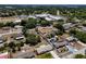 Wide aerial view of a neighborhood showcasing diverse homes and proximity to shopping centers at 2833 Beal St, Deltona, FL 32738