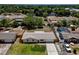 Aerial front view of a home showcasing a well-maintained lawn, trees, and proximity to neighborhood amenities at 2833 Beal St, Deltona, FL 32738