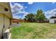 Expansive backyard with a covered patio, shed for storage, green lawn, and a wooden fence at 2833 Beal St, Deltona, FL 32738