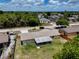 Aerial view of a home showcasing a spacious backyard, mature trees, and a screened porch at 2833 Beal St, Deltona, FL 32738
