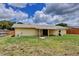 Spacious backyard featuring a covered patio, a well-maintained lawn, and a wooden fence at 2833 Beal St, Deltona, FL 32738
