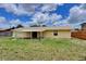 Expansive backyard with a covered patio, lush green lawn, and a privacy fence at 2833 Beal St, Deltona, FL 32738
