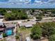 Aerial view of a home showcasing a spacious backyard, mature trees, and a screened porch at 2833 Beal St, Deltona, FL 32738