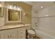 Bright bathroom featuring a vanity with ample storage and a combined bathtub and shower with tiled walls at 2833 Beal St, Deltona, FL 32738