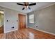 Bedroom with wood-look flooring, a ceiling fan, and a closet with bi-fold doors at 2833 Beal St, Deltona, FL 32738