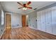 Bedroom has hardwood floors, a ceiling fan, and an ensuite bathroom at 2833 Beal St, Deltona, FL 32738
