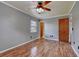Bright bedroom featuring a ceiling fan, wood-look flooring, and neutral paint at 2833 Beal St, Deltona, FL 32738