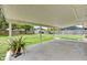 Covered patio with concrete flooring overlooking the large, grassy backyard and wooden fencing at 2833 Beal St, Deltona, FL 32738