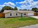 Charming front exterior of a single-story home boasts a lush lawn, and a attached garage with a private driveway at 2833 Beal St, Deltona, FL 32738