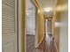 View down hallway showing wood look floors and view into the living room at 2833 Beal St, Deltona, FL 32738