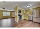The open-concept kitchen has stainless steel appliances, updated backsplash, and hardwood-style floors at 2833 Beal St, Deltona, FL 32738