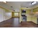 Open floor plan showcasing the kitchen with stainless steel appliances and hardwood flooring at 2833 Beal St, Deltona, FL 32738