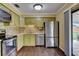 Modern kitchen featuring stainless steel appliances, updated cabinetry, and hardwood floors at 2833 Beal St, Deltona, FL 32738
