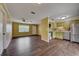 A charming open-concept living room and kitchen featuring wood floors and stainless steel appliances at 2833 Beal St, Deltona, FL 32738