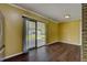 The brightly lit living room features hardwood style floors and a sliding glass door that leads to the patio at 2833 Beal St, Deltona, FL 32738