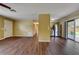 The open-concept living room features hardwood-style floors, light-colored walls, and an abundance of natural light at 2833 Beal St, Deltona, FL 32738