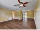 The living room boasts beautiful hardwood-style floors, a ceiling fan, and lots of room to relax at 2833 Beal St, Deltona, FL 32738