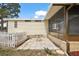 The back patio has a small table and a small white picket fence at 2921 Wekiva Rd, Tavares, FL 32778