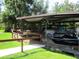 Covered boat slip featuring power boat and pontoon boat storage along a canal at 2921 Wekiva Rd, Tavares, FL 32778