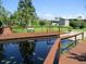 Wooden dock with canal access and neighborhood in the background at 2921 Wekiva Rd, Tavares, FL 32778