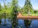 View from wooden dock of canal with bench on the dock at 2921 Wekiva Rd, Tavares, FL 32778