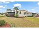 Well maintained home with a beautiful lawn, manicured bushes, and a screened-in porch at 2921 Wekiva Rd, Tavares, FL 32778