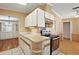 Cozy kitchen featuring tile backsplash, laminate countertops, and stainless steel appliances at 2921 Wekiva Rd, Tavares, FL 32778