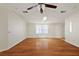 This living room has hardwood floors, a ceiling fan, and a beautiful window at 2921 Wekiva Rd, Tavares, FL 32778