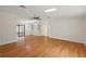 A spacious living room with hardwood floors, a ceiling fan, and an ornate built-in cabinet at 2921 Wekiva Rd, Tavares, FL 32778