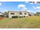 The side of the home features manicured landscaping and a well-kept lawn at 2921 Wekiva Rd, Tavares, FL 32778