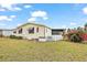 The well-manicured side yard with small white picket fence and a large flowering bush at 2921 Wekiva Rd, Tavares, FL 32778