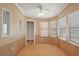 Bright sun room with multiple windows and wood paneling at 2921 Wekiva Rd, Tavares, FL 32778