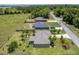 Aerial view of the house and landscaping on a lush green lawn at 30 Olive Cir, Ocala, FL 34472