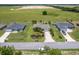 An aerial view of the house showcasing the lawn, landscaping, and driveway at 30 Olive Cir, Ocala, FL 34472