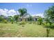 A lovely lawn with palm trees and view of the rear of the house at 30 Olive Cir, Ocala, FL 34472