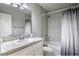 Bathroom with vanity, granite countertop, shower-tub combo, and stylish shower curtain at 30 Olive Cir, Ocala, FL 34472