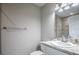 Bathroom with sink, white cabinets, granite countertop, tile backsplash, toilet, and towel rack at 30 Olive Cir, Ocala, FL 34472