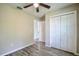A cozy bedroom featuring wood-look floors and a double door closet at 30 Olive Cir, Ocala, FL 34472