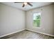 A cozy bedroom featuring wood-look floors and a window with green view at 30 Olive Cir, Ocala, FL 34472