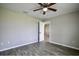 Bedroom featuring new gray floors, ceiling fan, and a view to the doorway at 30 Olive Cir, Ocala, FL 34472