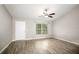 Bright bedroom featuring modern flooring, a ceiling fan, and natural light at 30 Olive Cir, Ocala, FL 34472