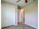 A cozy bedroom featuring wood-look floors and a double door closet at 30 Olive Cir, Ocala, FL 34472