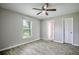 Bedroom featuring ceiling fan, window with blinds, and new gray floors at 30 Olive Cir, Ocala, FL 34472