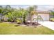 Charming home with well-manicured lawn and lush tropical landscaping around the entrance at 30 Olive Cir, Ocala, FL 34472