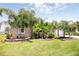 A well maintained yard, with beautiful tropical landscaping framing a cozy home at 30 Olive Cir, Ocala, FL 34472
