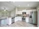Modern kitchen with stainless steel appliances, and open to an adjacent living area at 30 Olive Cir, Ocala, FL 34472