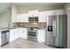 Modern kitchen with stainless steel appliances, granite counters, and open layout at 30 Olive Cir, Ocala, FL 34472